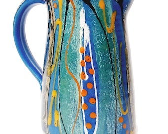 Handmade stoneware ceramic jug, around 15cm tall. Deep blue satin glaze exterior, fresh glossy turquoise inside.