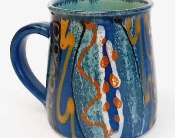 Large handmade stoneware ceramic mug, deep blue glaze with vibrant colourful decoration, fresh turquoise glaze inside.
