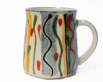 Large handmade stoneware mug in Beach design, individualy decorated mug with free form bright striped decoration. A high fired robust mug.