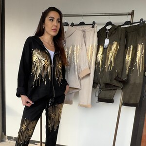 Foil printed knitted jersey jumper and pant tracksuit set for ladies. Cotton and polyester blended yarns will have soft hand feel in use.