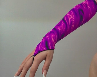 May include: A purple and pink arm warmer with a swirl pattern. The arm warmer has a black trim and a finger hole.