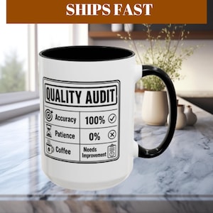 May include: A white ceramic mug with a black interior and handle. The front features a black graphic resembling a quality audit checklist with the text: QUALITY AUDIT, Accuracy 100%, Patience 0%, and Coffee Needs Improvement with icons.