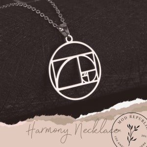 May include: A silver necklace with a circular pendant featuring a geometric design inspired by the Golden Ratio. The pendant is inscribed with the text "Harmony Necklace".