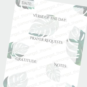 May include: A white printable planner page with a tropical leaf pattern. The page has sections for date, verse of the day, prayer requests, gratitude, and notes.