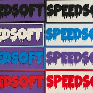 May include: A collection of 16 rectangular patches with the word "SPEEDSOFT" printed in various colors, including red, black, white, blue, and purple. The letters have a dripping effect, giving the patches a unique and edgy look.