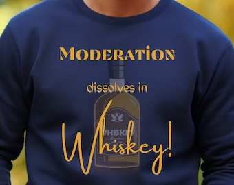 May include: A navy blue sweatshirt with the text "Moderation dissolves in Whiskey!" printed in yellow. The text is accompanied by a graphic of a whiskey bottle.