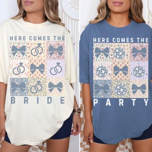 May include: Two t-shirts with a patchwork design. The shirt on the left is ivory and says "Here Comes The Bride". The shirt on the right is blue and says "Here Comes The Party".