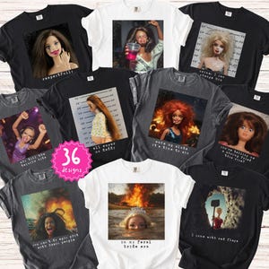 May include: Collection of graphic t-shirts in various colors, featuring images of dolls with text overlays. The shirts display phrases like "respectfully," "all sugar no daddy," and "in my feral bride era." The collection includes 36 designs.