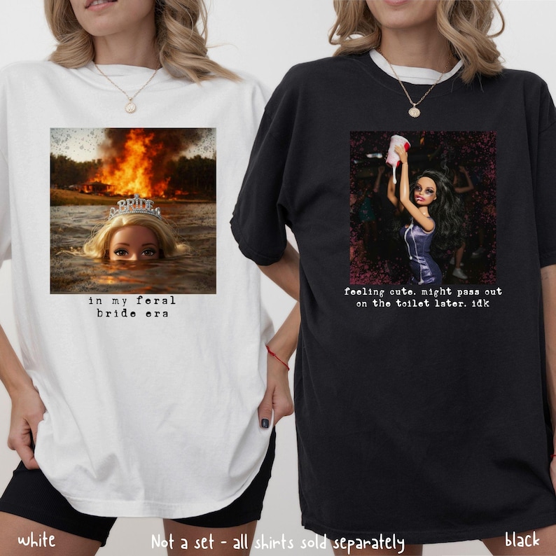 May include: Two oversized t-shirts, one white and one black. The white shirt features a graphic of a doll in water with a burning background and the text "in my feral bride era." The black shirt has a doll graphic and the text "feeling cute, might pass out on the toilet later. idk."