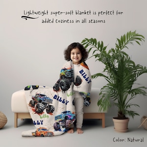 May include: A white fleece blanket with a colorful monster truck design. The blanket features the name "BILLY" repeated throughout the design.