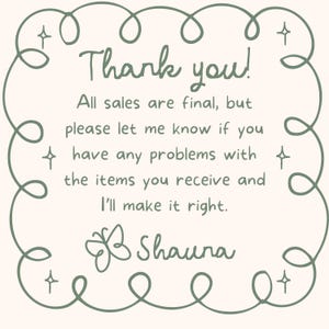 May include: A cream-colored card with a green border and text that reads "Thank you!" and other text. The card also includes the name "Shauna" and a butterfly illustration.