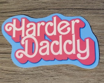 May include: A blue and pink sticker with the text "Harder Daddy" in a retro font.