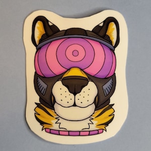 May include: A sticker of a cartoon animal head wearing a futuristic helmet with pink and purple glowing eyes. The animal has a black nose and yellow fur around its neck.