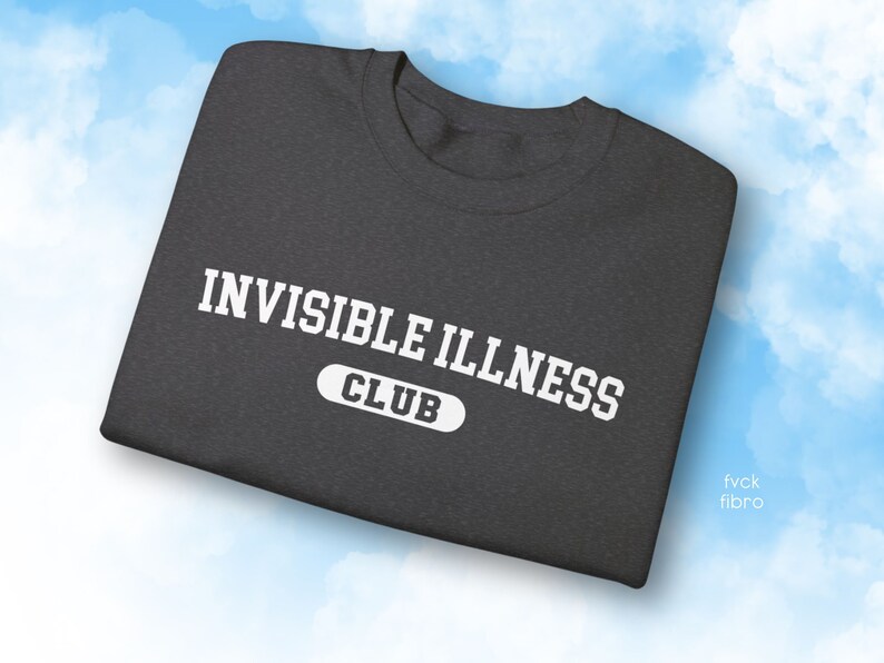 May include: A dark grey t-shirt with white text that reads "Invisible Illness Club".