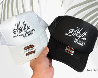 May include: Two black and white trucker hats with mesh back panels. The hats feature the text "til Death" in a cursive font with different subtext below. The white hat has "The Joneses VIII.X.MMXXI" and the black hat has "Phil & Tee VIII.X.MMXXI".