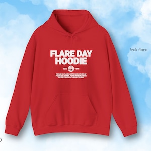 May include: A red hoodie with the text "FLARE DAY HOODIE" in white, along with additional text and a globe graphic. The hoodie has a front pocket and a drawstring hood. The word "RED" is at the bottom left.