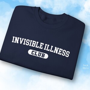 May include: A navy blue sweatshirt with white text that reads "Invisible Illness Club".