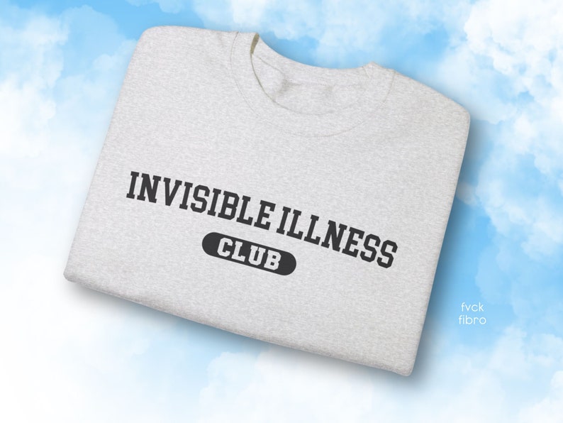 May include: A grey t-shirt with the text "INVISIBLE ILLNESS CLUB" printed in black.