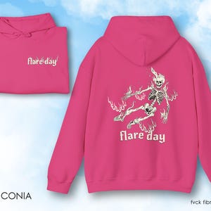 May include: Pink hoodie with a skeleton graphic and the text "flare day" on the back. The front of the hoodie has the text "flare'day" in white.