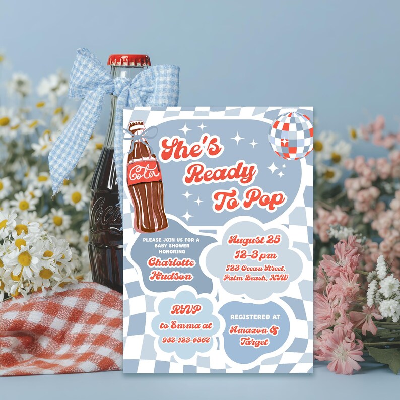 May include: A baby shower invitation with the text "She's Ready To Pop" in red and white. The invitation is light blue with a checkered pattern and features a cartoon Coca-Cola bottle. A Coca-Cola bottle with a blue bow is in the background.