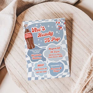 May include: A baby shower invitation with a retro design. The invitation features the text "She's Ready To Pop" in red script, along with a Coca-Cola bottle illustration. Additional text includes the date, time, location, and RSVP information.