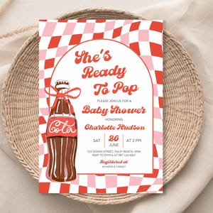 May include: Baby shower invitation with a retro design. The invitation features a red and pink checkered background and a cola bottle illustration. Text includes "She's Ready To Pop" and event details.
