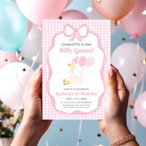 May include: Pink and white gingham invitation with a cartoon goose wearing a pink hat and holding pink balloons. The text reads "Charlotte is one Silly Goose!" and "Rachael's 1st Birthday".