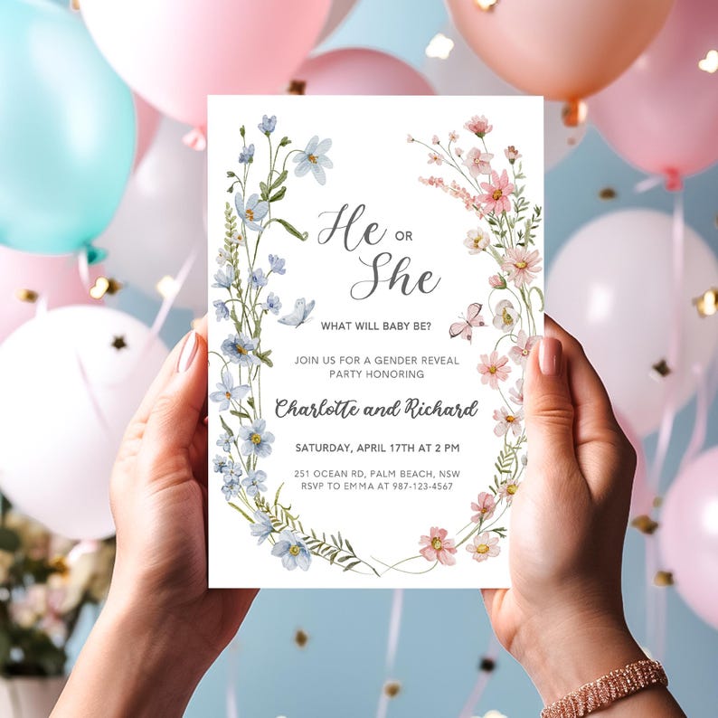 May include: A gender reveal party invitation with a floral wreath design in blue and pink. The text reads "He or She? What will baby be? Join us for a gender reveal party honoring Charlotte and Richard. Saturday, April 17th at 2 PM. 251 Ocean Rd, Palm Beach, NSW. RSVP to Emma at 987-123-4567."