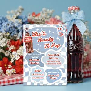 May include: A baby shower invitation with a retro theme. The invitation features a Coca-Cola bottle illustration and the text "She's Ready To Pop." The invitation includes event details and a disco ball graphic. A Coca-Cola bottle with a blue bow is also in the image.