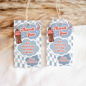 May include: Two rectangular gift tags with a retro design. Each tag features a brown soda bottle, the words "Thank You," and the message "for showering our baby with love." The tags are light blue with a checkered pattern.