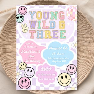 May include: A colorful invitation for a 3rd birthday party with the text "Young Wild & Three" in a rainbow font. The invitation features a checkered background, smiley faces, and a peace sign.