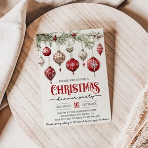May include: A Christmas dinner party invitation with a watercolor illustration of red and white ornaments hanging from a pine branch. The text reads "Please join us for a Christmas dinner party, Saturday 16 December, 6:00 PM at the Johnson's Home, 29 Montreal Ave, Regina, CA, RSVP by Dec to Emma at 987-23-, Please bring along a 10$ secret Santa gift to share."
