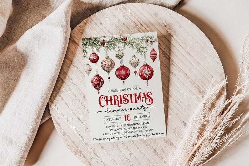 May include: A Christmas dinner party invitation with a watercolor illustration of red and white ornaments hanging from a pine branch. The text reads "Please join us for a Christmas dinner party, Saturday 16 December, 6:00 PM at the Johnson's Home, 29 Montreal Ave, Regina, CA, RSVP by Dec to Emma at 987-23-, Please bring along a 10$ secret Santa gift to share."