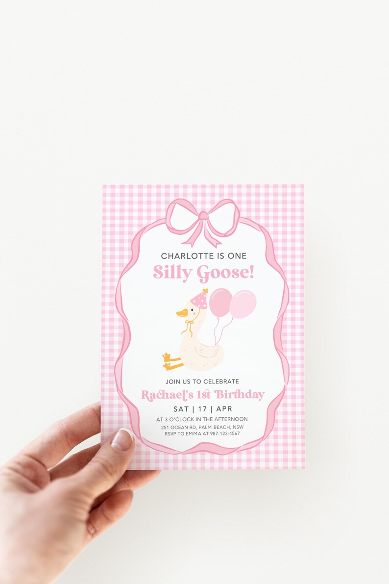 May include: Pink and white gingham patterned invitation with a white goose wearing a party hat and holding balloons. The text reads "Charlotte is one Silly Goose!" and "Join us to celebrate Rachael's 1st Birthday SAT 17 APR at 3 o'clock in the afternoon 251 Ocean Rd, Palm Beach, NSW RSVP to Emma at 987-123-4567"