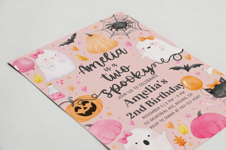 May include: Pink Halloween-themed invitation with the text "Amelia is a two spooky" and "Amelia's 2nd Birthday." The design includes illustrations of ghosts, pumpkins, bats, and a spiderweb. The invitation is for a birthday party.