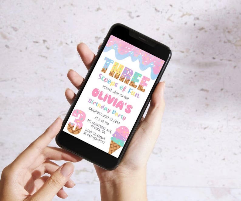 May include: A smartphone displays a colorful birthday party invitation. The invitation features the text "THREE Scoops of Fun" and "Olivia's Birthday Party." Decorative ice cream cones and sprinkles adorn the design. The date is Saturday, July 27, 2024.