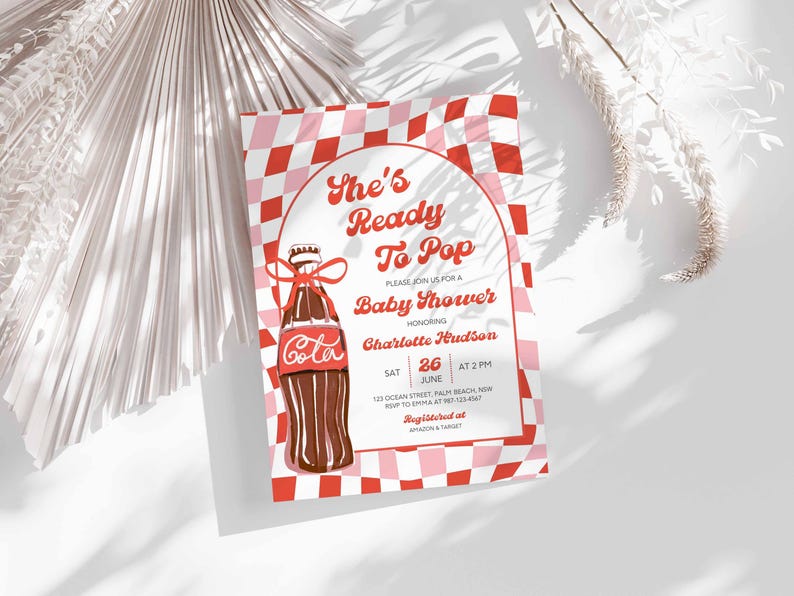May include: Baby shower invitation with a red and pink checkered background. The invitation features a vintage-style illustration of a cola bottle with a red bow. Text includes "She's Ready To Pop" and event details.