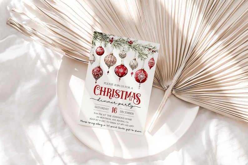 May include: A Christmas dinner party invitation with a watercolor illustration of red and gold ornaments hanging from a pine branch. The text reads "Please join us for a Christmas dinner party, Saturday, December 16, 6:00 PM at the Johnson's Home, 30 Montreal Ave, Regina, CA, RSVP by Dec 10 to Emma at 587-123-4567, Please bring along a $10 secret Santa gift to share."