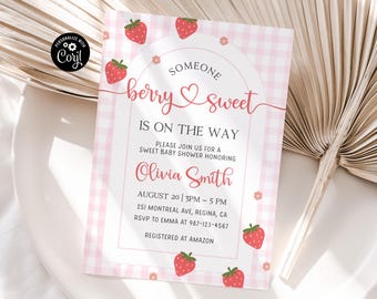 May include: Pink and white gingham baby shower invitation with a strawberry theme. The text reads "Someone berry sweet is on the way".