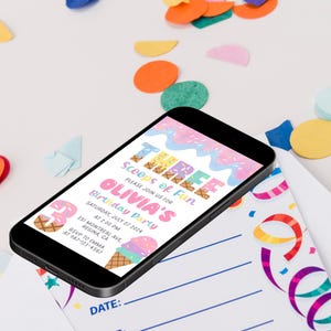 May include: A smartphone displays a colorful birthday party invitation. The invitation reads "THREE Scoops of Fun" and includes details for Olivia's party on July 27, 2024, at 2:00 PM. The design features ice cream cones and pastel colors. Confetti surrounds the phone.