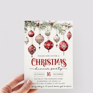 May include: A Christmas dinner party invitation with a red and white color scheme. The invitation features a festive illustration of red and white ornaments hanging from a pine branch. The text reads "Please join us for a Christmas dinner party Saturday 16 December 6:00 PM at the Johnson's Home 251 Montreal Ave, Regina, CA RSVP by 10 Dec to Emma at 987-123-4567 bring along a 10$ secret Santa gift to share".