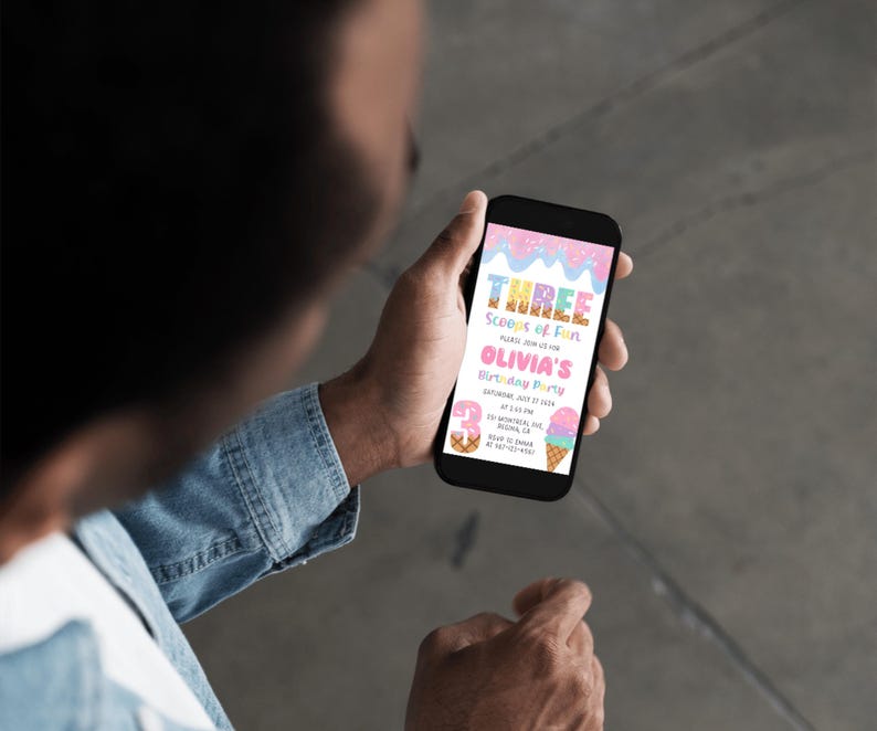 May include: A person holding a smartphone displaying a birthday party invitation. The invitation features the text "Three Scoops of Fun" and "Olivia's Birthday Party" in pink and blue colors, with ice cream cone illustrations.