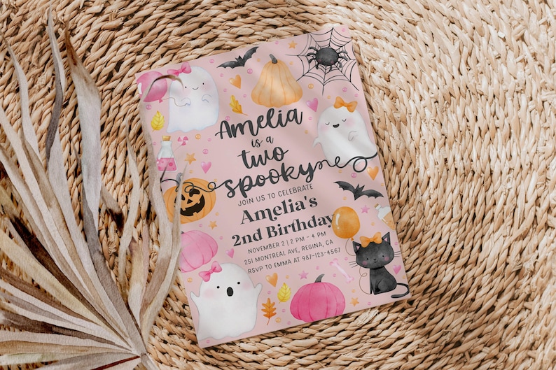 May include: A pink Halloween-themed invitation with the text "Amelia is a two spookyne" and details for a 2nd birthday party. The design includes ghosts, pumpkins, bats, and a black cat with a bow.