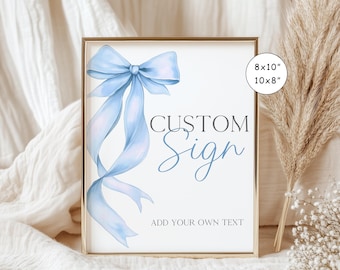May include: A printable sign featuring a blue bow and the text "CUSTOM Sign" and "ADD YOUR OWN TEXT". The sign is available in 8x10 inches or 10x8 inches.