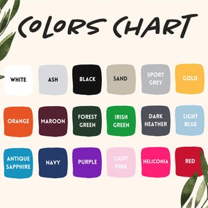 May include: A color chart featuring the text COLORS CHART at the top with fifteen rounded squares in various colors including white, ash, black, sand, sport grey, gold, orange, maroon, forest green, irish green, dark heather, light blue, antique sapphire, navy, purple, light pink, heliconia, and red.