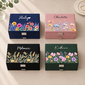 May include: Four rectangular velvet jewelry boxes in navy blue, dusty pink, black, and forest green. Each box features a floral print on the lid and a personalized name: Hailey, Charlotte, Melanie, or Katherine. Each box has a metal latch and drawer.