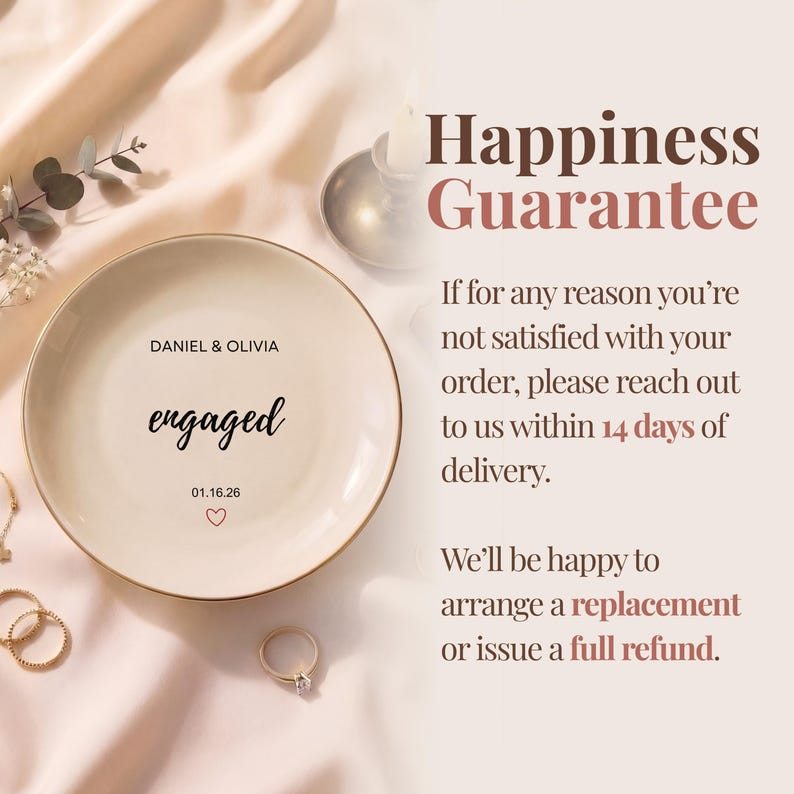 May include: A cream-colored ceramic engagement ring dish with a gold rim. The dish is inscribed with "DANIEL & OLIVIA" above the word "engaged" and the date "01.16.26" with a heart symbol. A diamond ring is next to the dish.