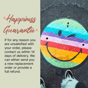 a colorful, multicolored manhole cover with a smiley face drawn on it. The manhole cover is placed on a street, and there is a person's feet visible in the bottom right corner of the image.