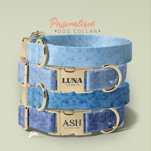a collection of personalized dog collars in various colors, including blue, light blue, and dark blue. The collars have gold buckles and engraved names, such as "Luna" and "Ash".