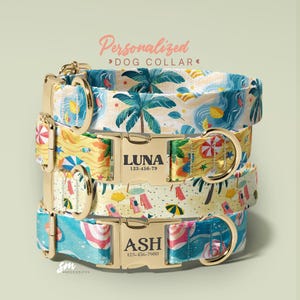 May include: Stacked personalized dog collars with beach-themed patterns. The collars feature gold-colored hardware and are printed with names and phone numbers. The top collar says "LUNA" and the bottom collar says "ASH". The collars have a tropical beach design.